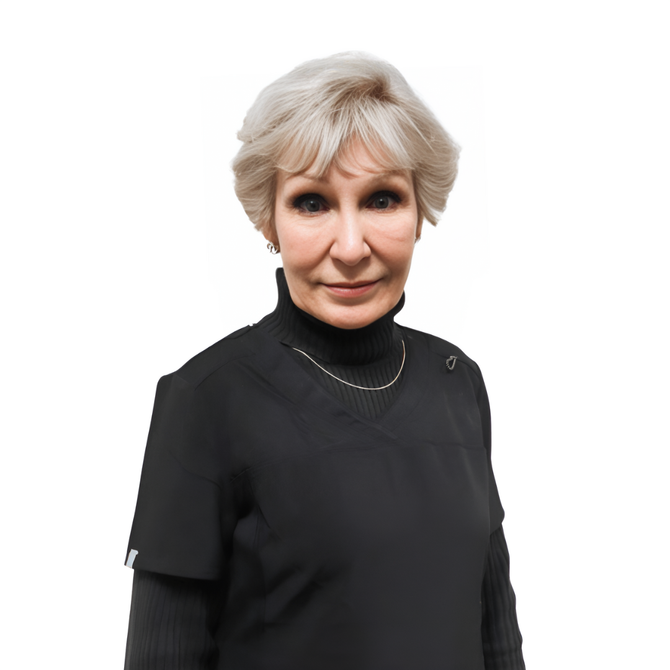 A woman with gray hair is wearing a black turtleneck and a necklace.