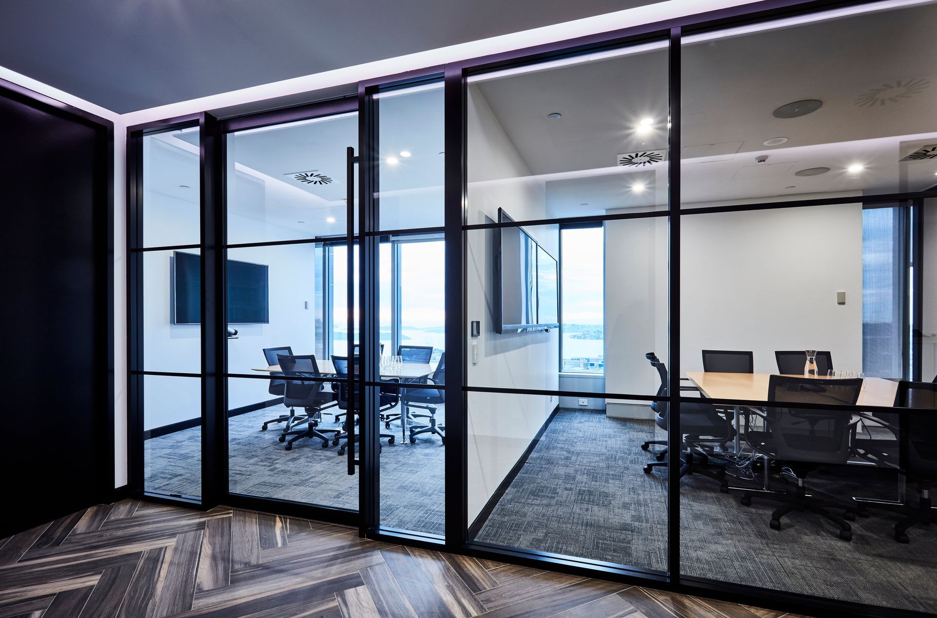 A conference room with a table and chairs in it.