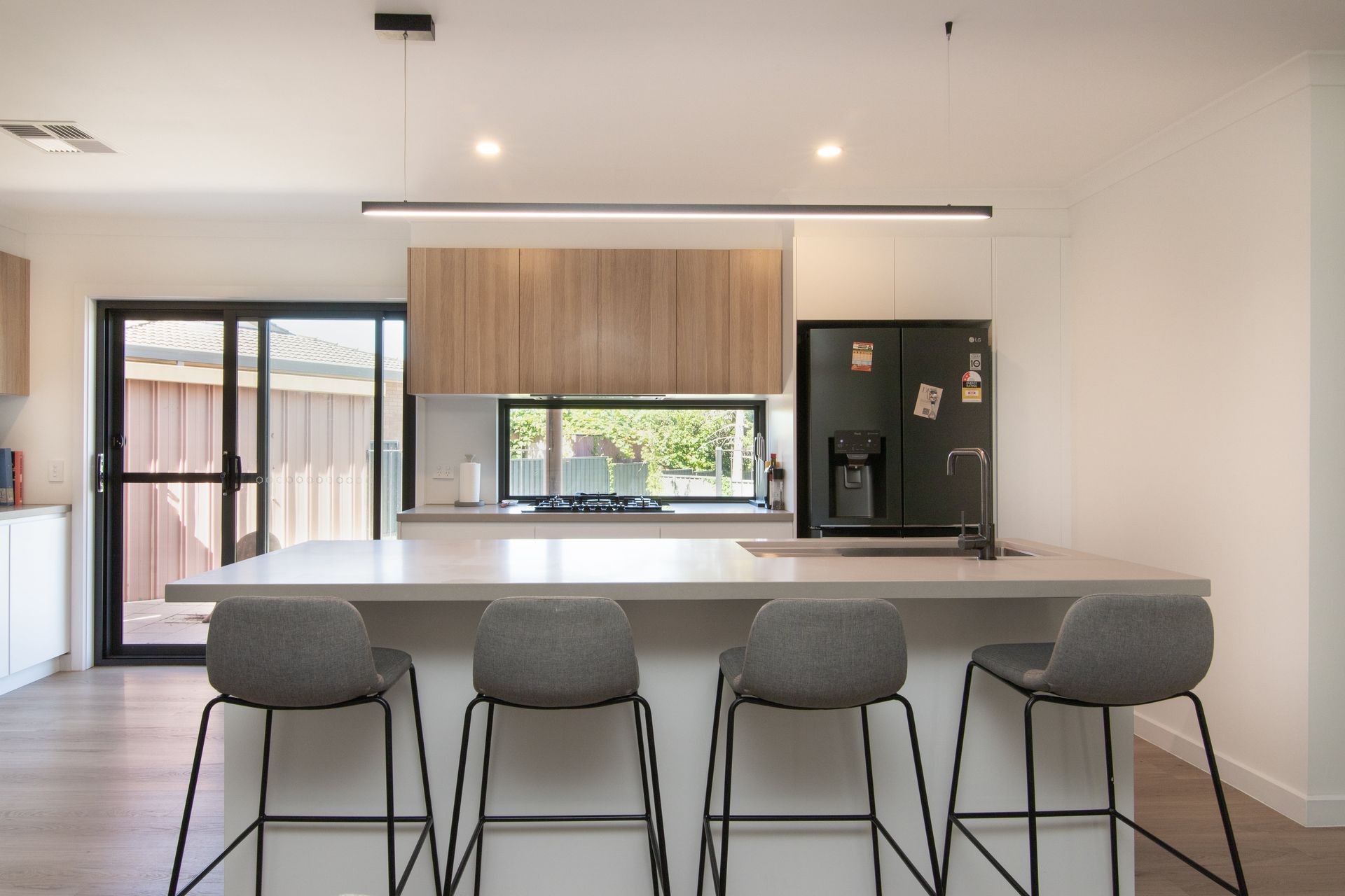 A kitchen with a large island and four stools