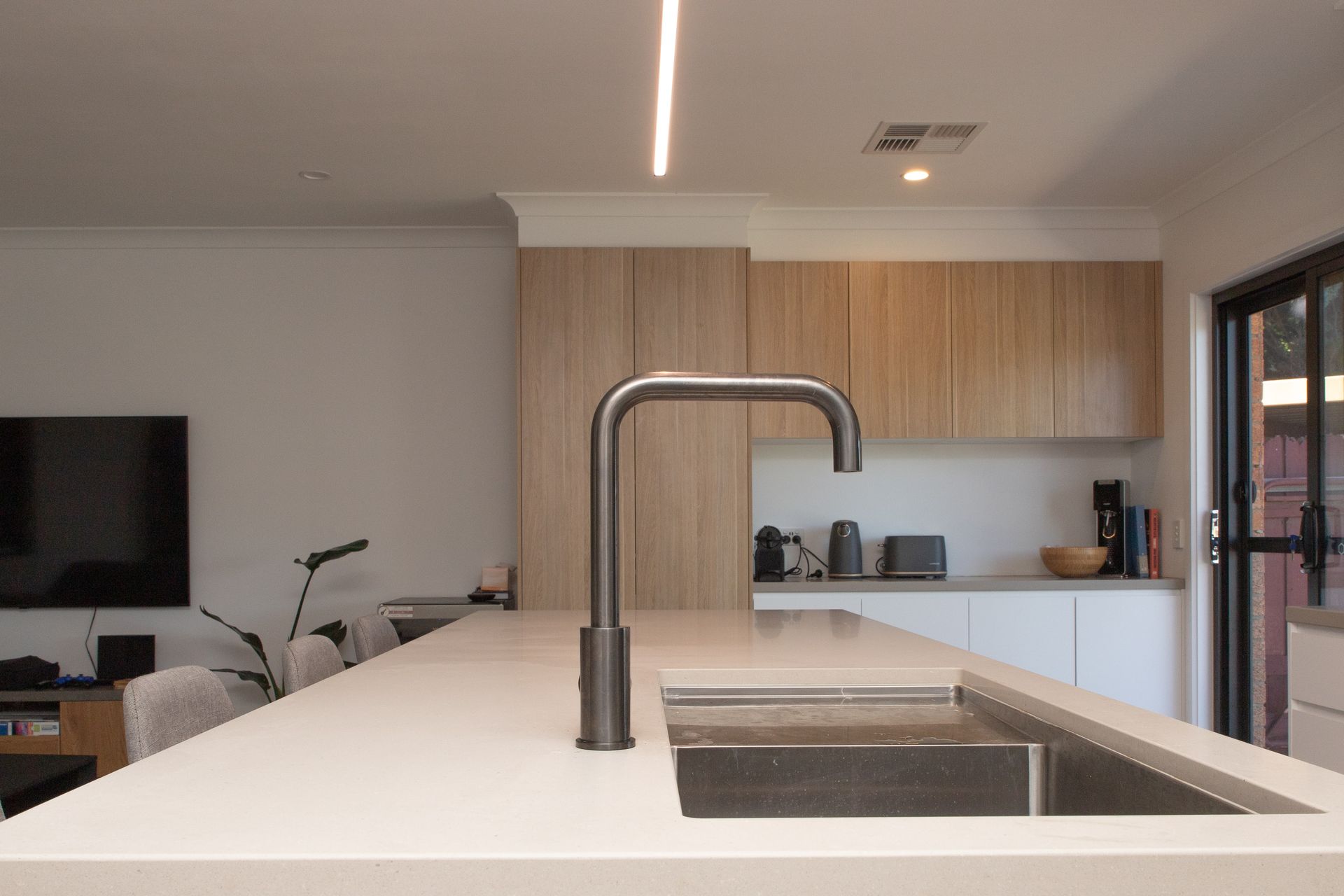 A kitchen with a stainless steel sink and a faucet.