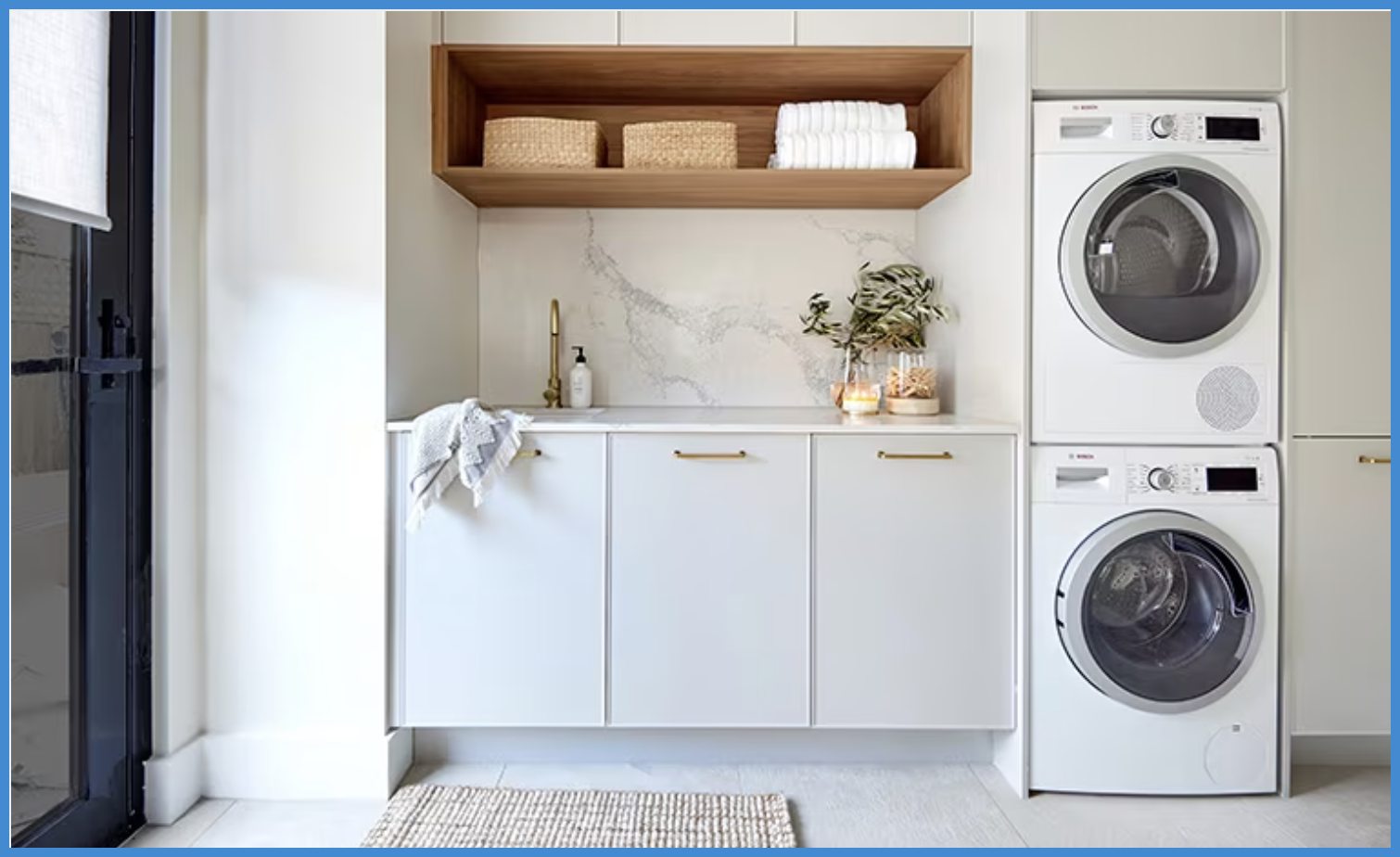 A laundry room with a washer and dryer stacked on top of each other.