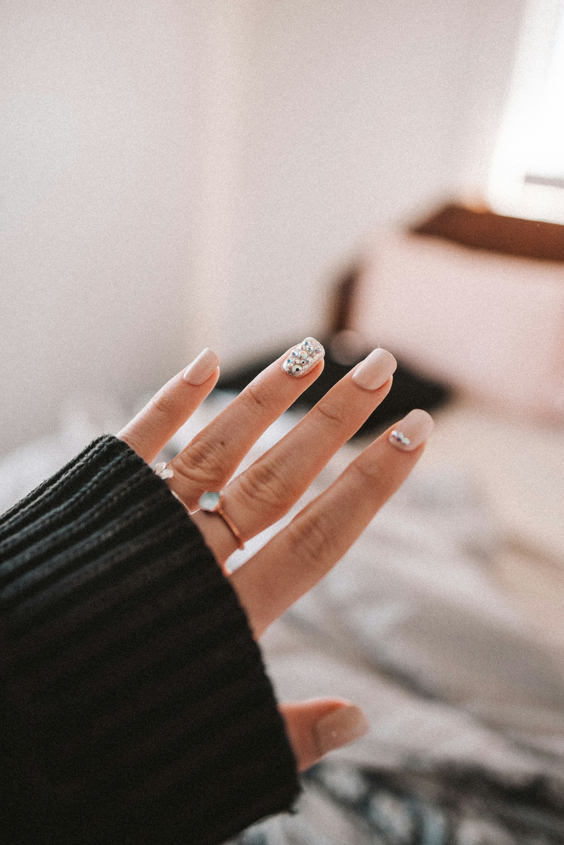 A close up of a person 's hand with a ring on it.