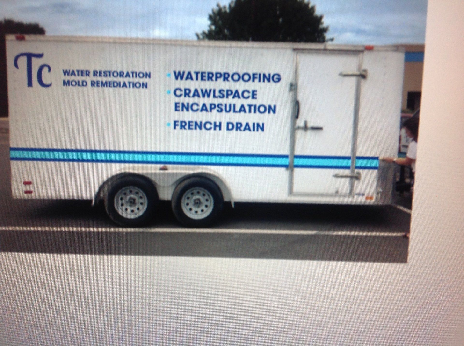 A white trailer that says tc on the side