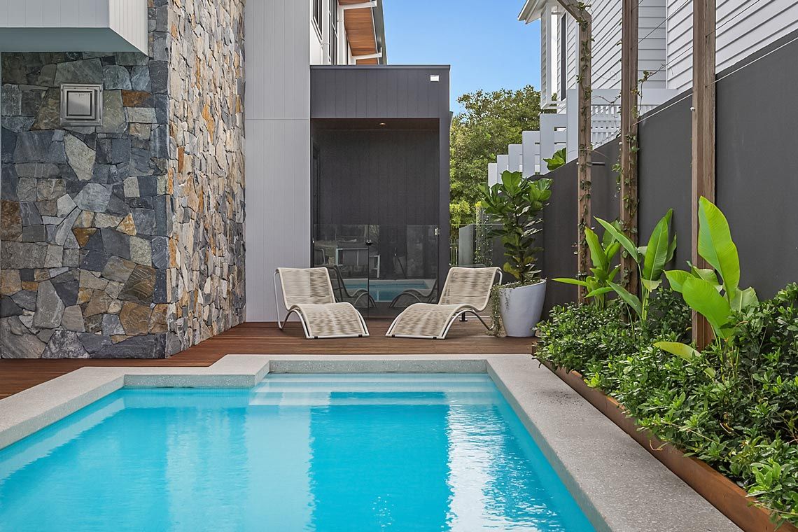 Backyard Pool With Sun Beds In Backyard — Quality Swimming Pools in Coolangatta, QLD