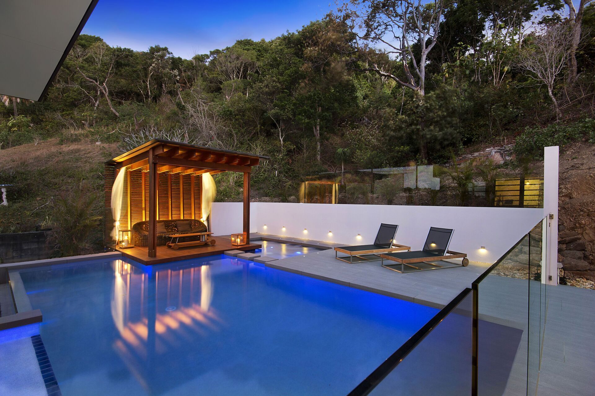 outdoor swimming pool on deck at night - Coastal Pools Coolangatta