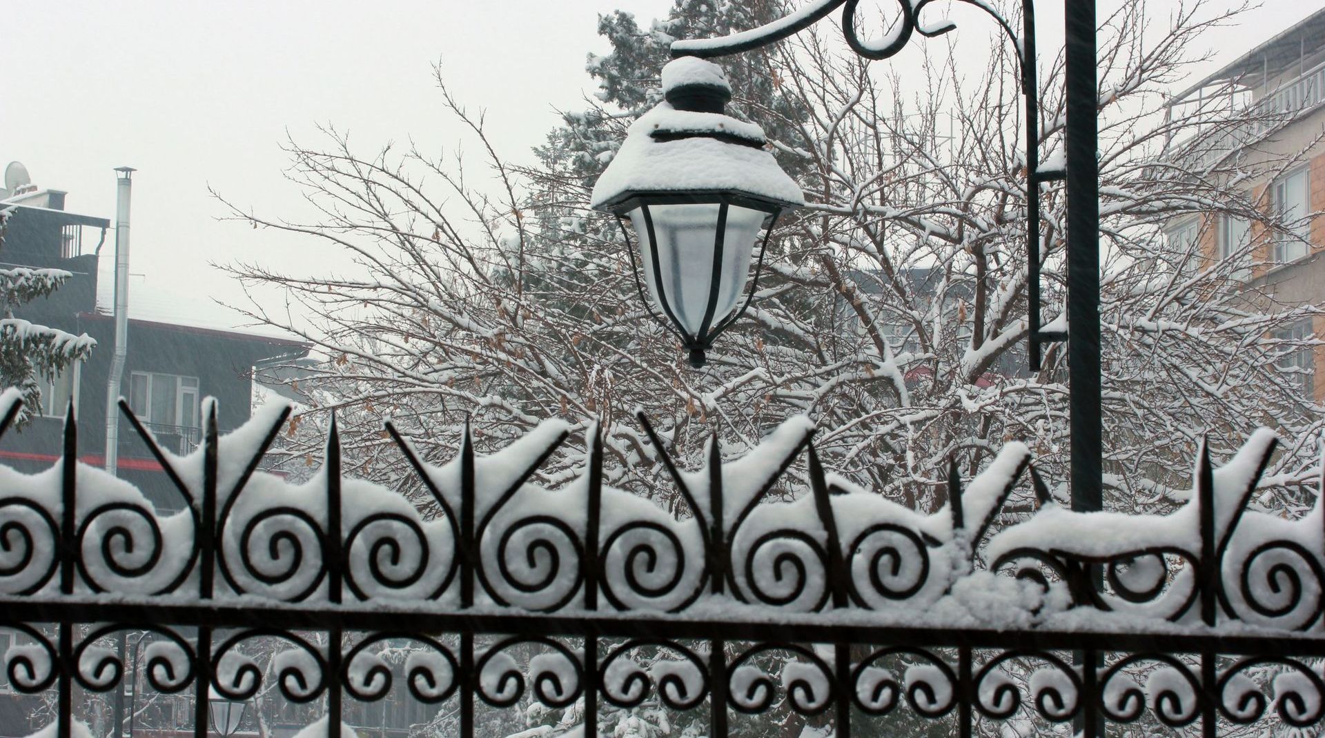 snow covered wrought iron fence installed by Longview Fence