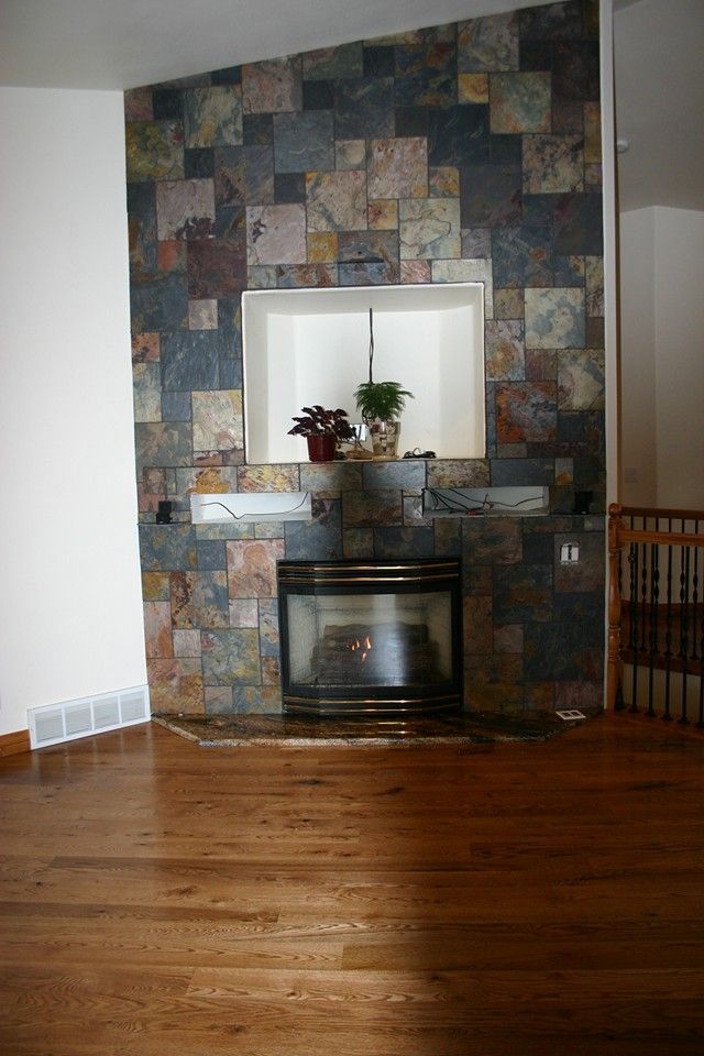 Woman in straw hat smiles, holding wine glass near a lake.