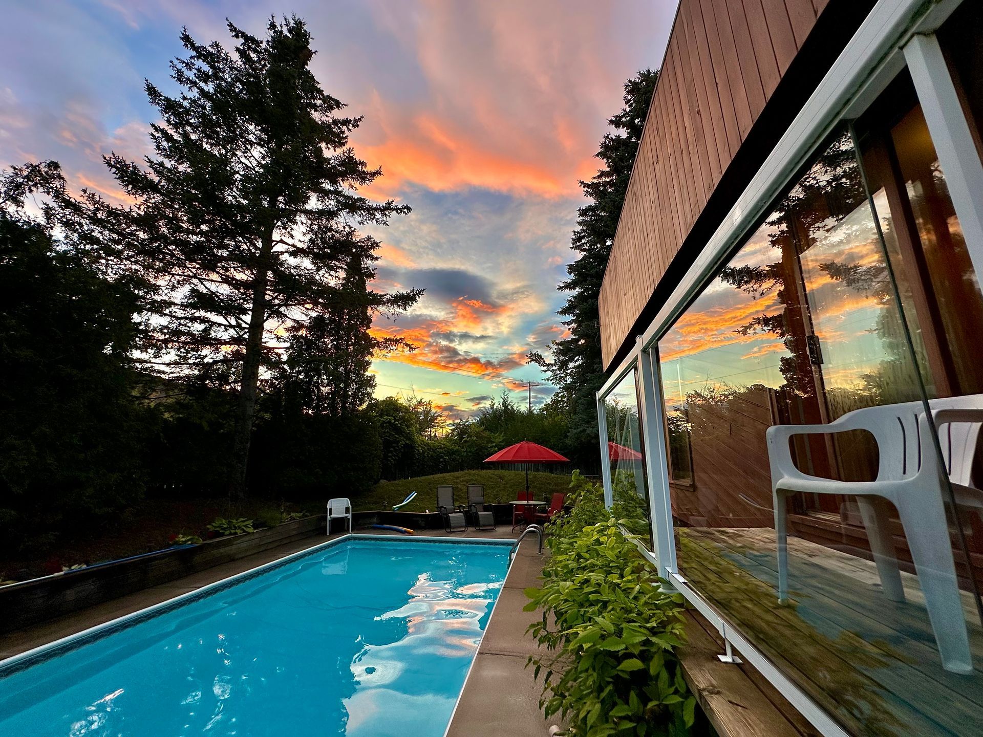 A large swimming pool with a sunset in the background