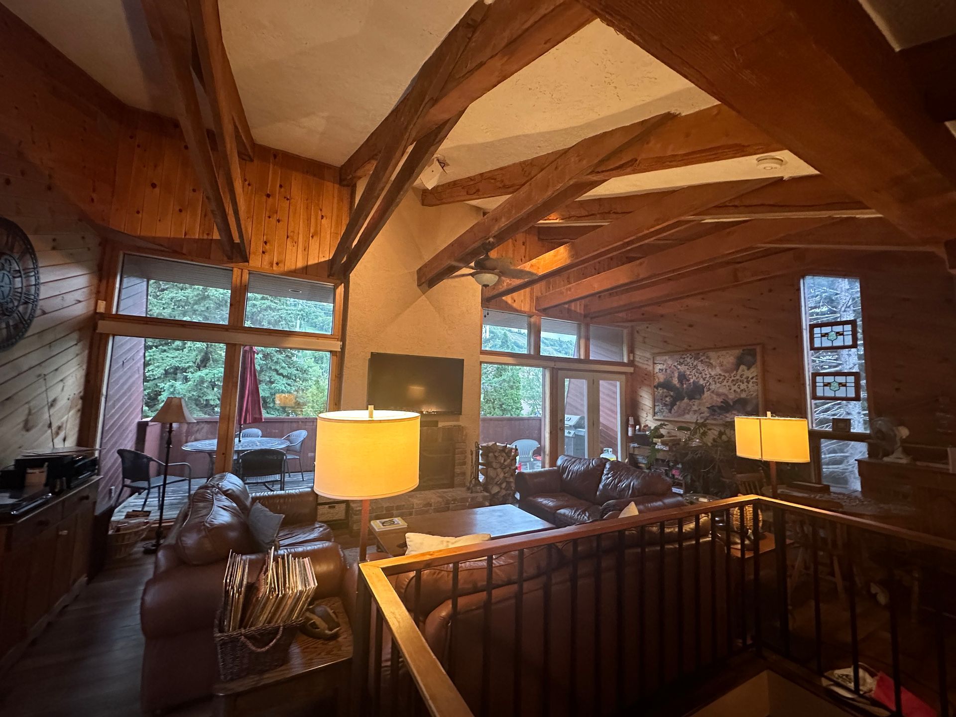 A living room with a lot of furniture and a ceiling fan