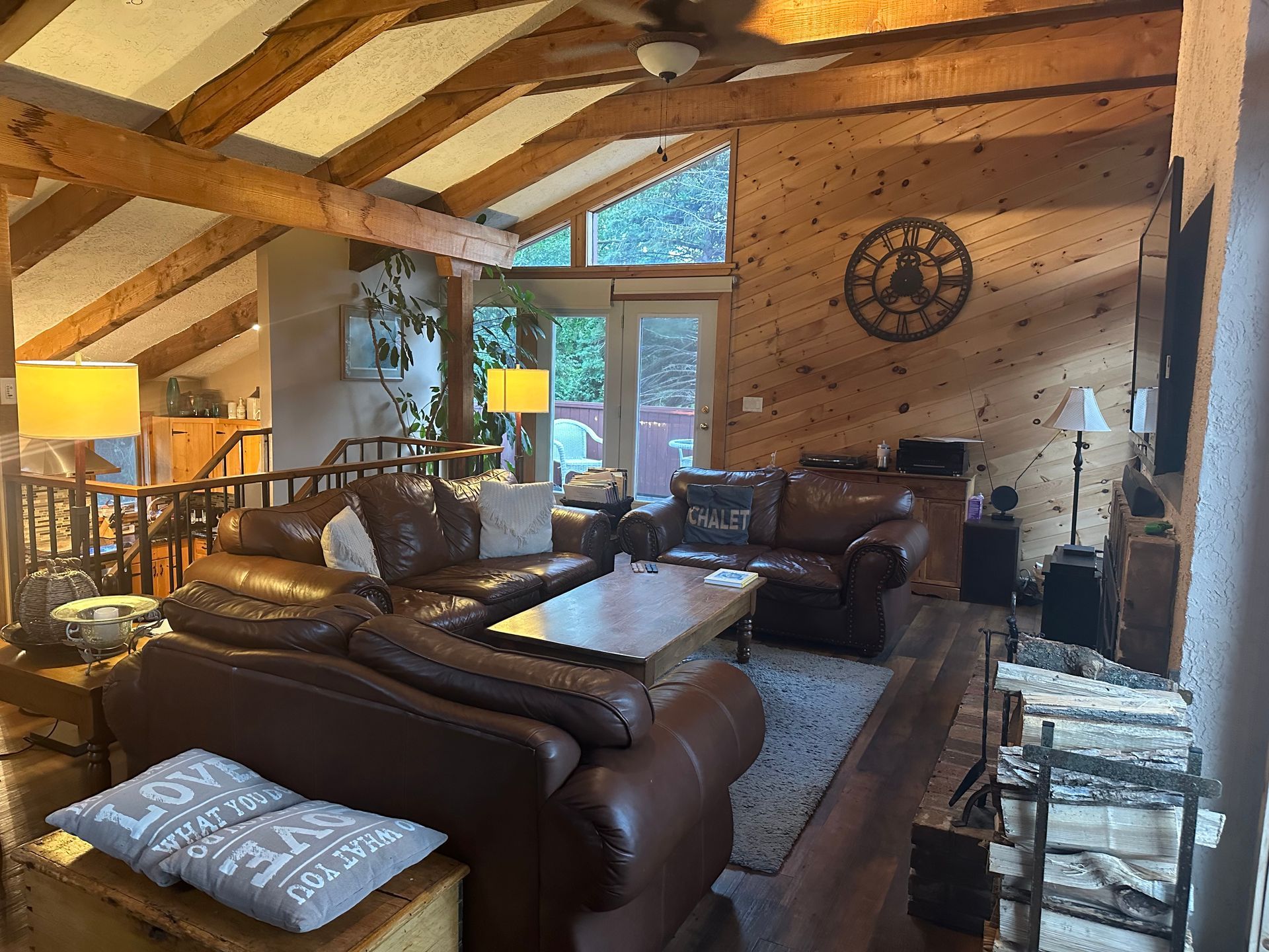 A living room filled with furniture and a clock on the wall.