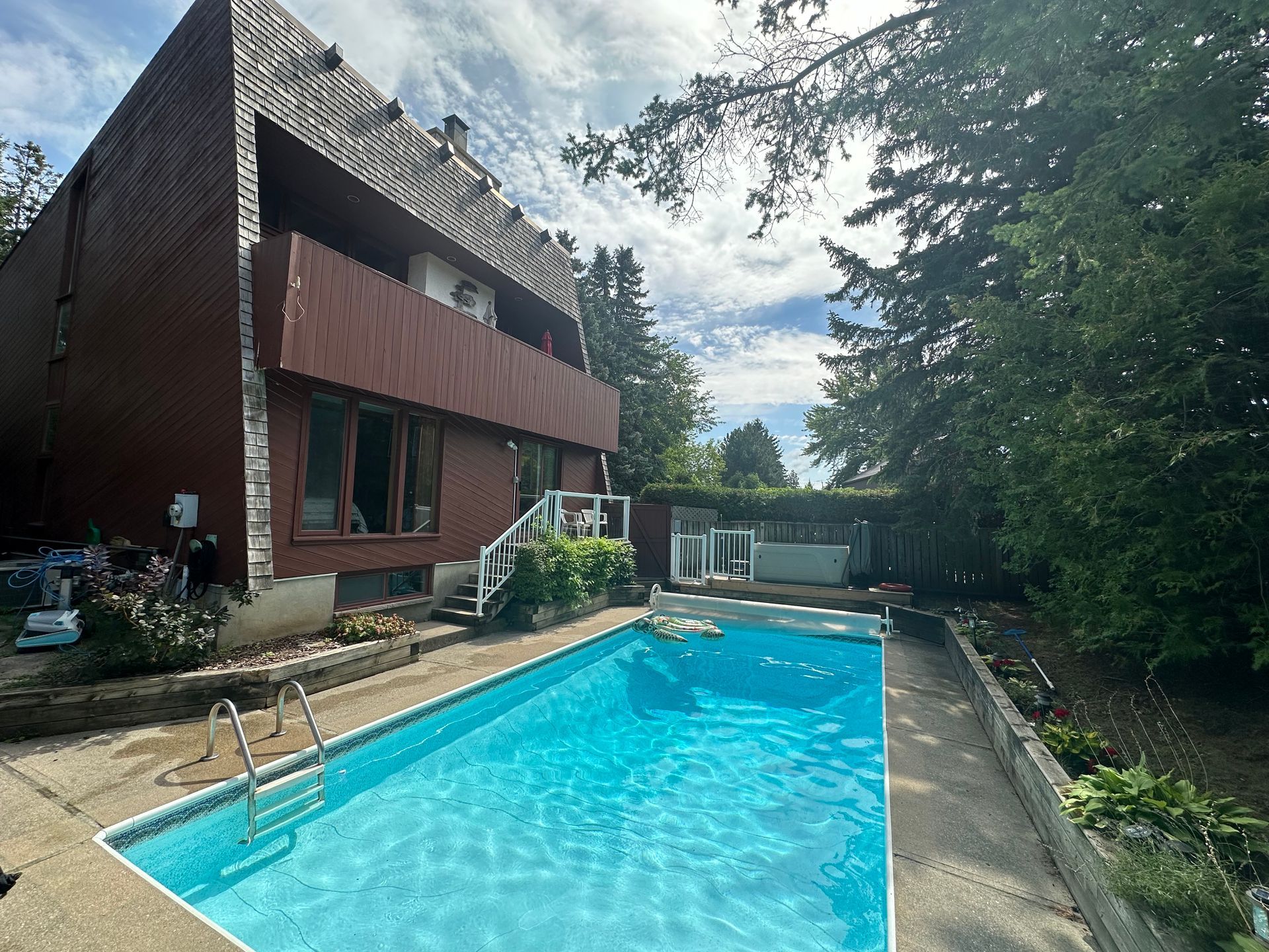 A large house with a swimming pool in front of it