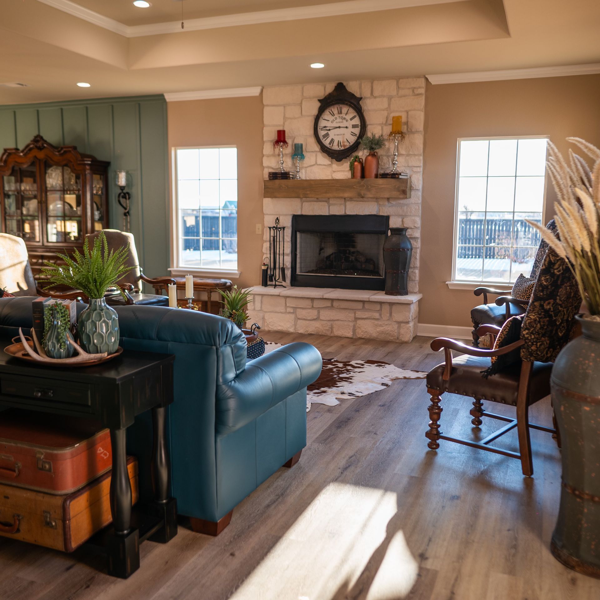 A living room with a blue couch and a fireplace