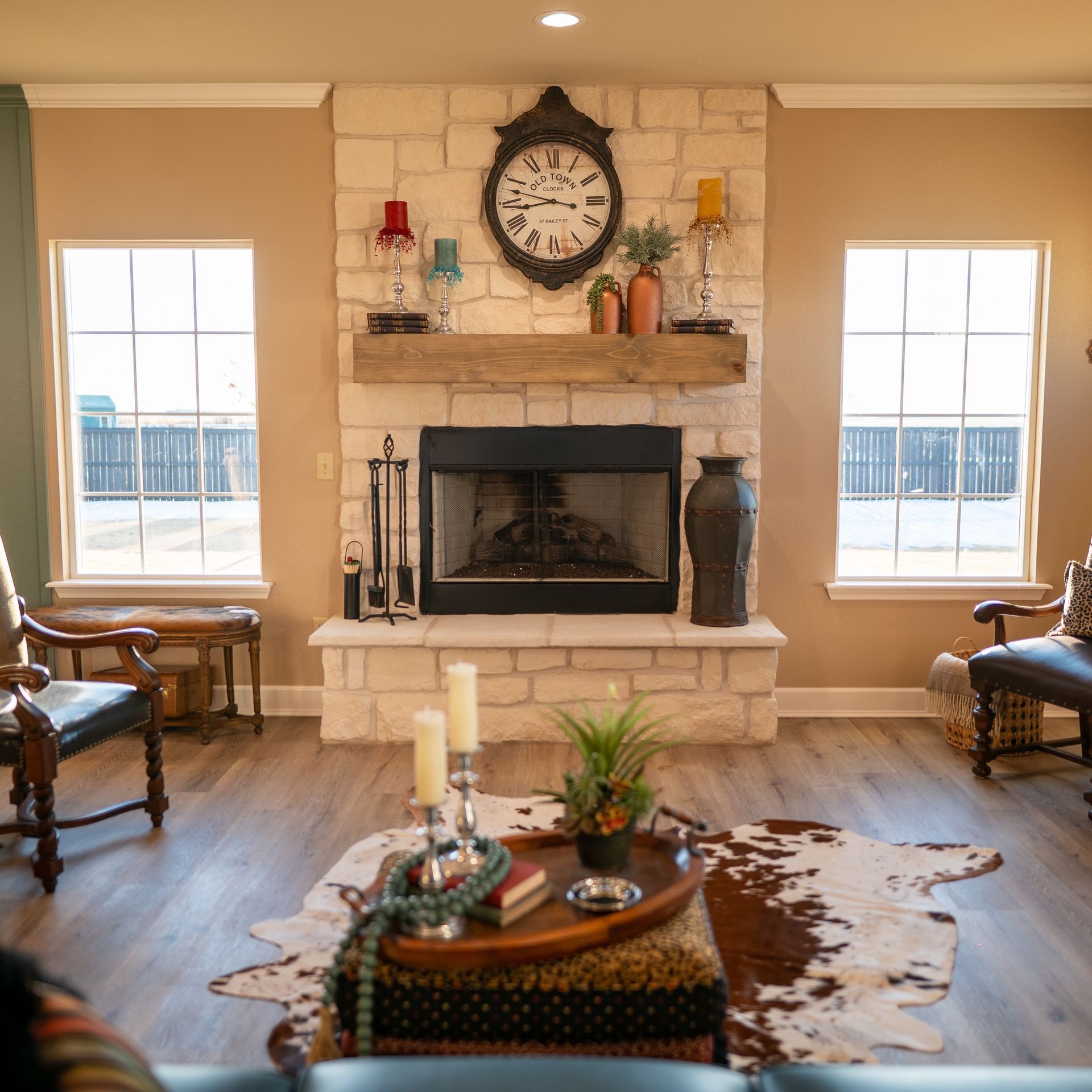 A living room with a fireplace and a clock above it