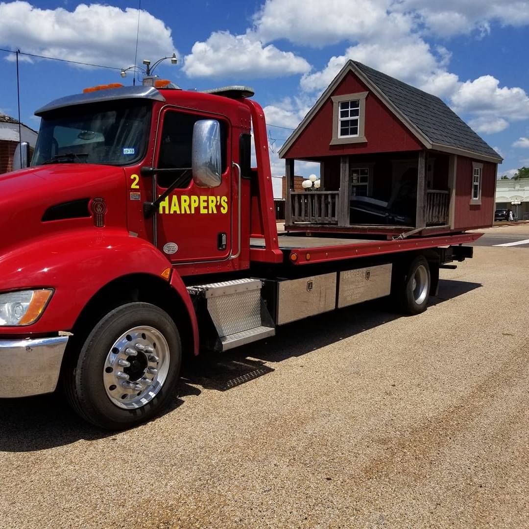 A red tow truck with harper 's written on the side