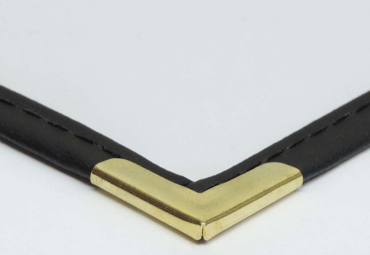 a close up of a picture frame with a gold corner