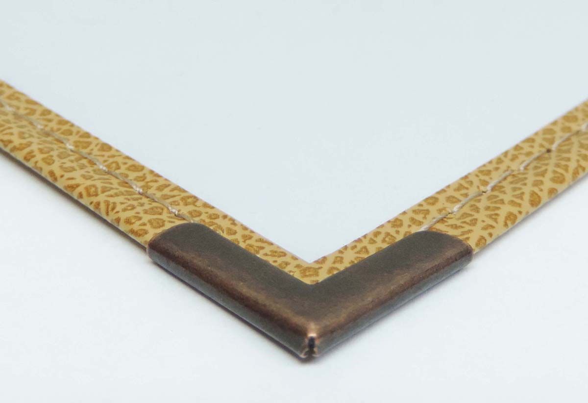 a close up of a picture frame with a brown corner
