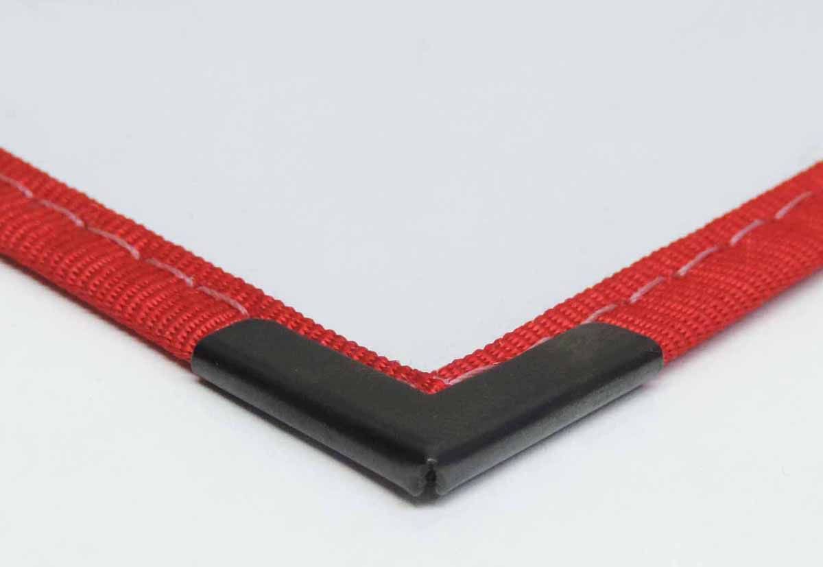 a white piece of paper with a red ribbon and a black corner