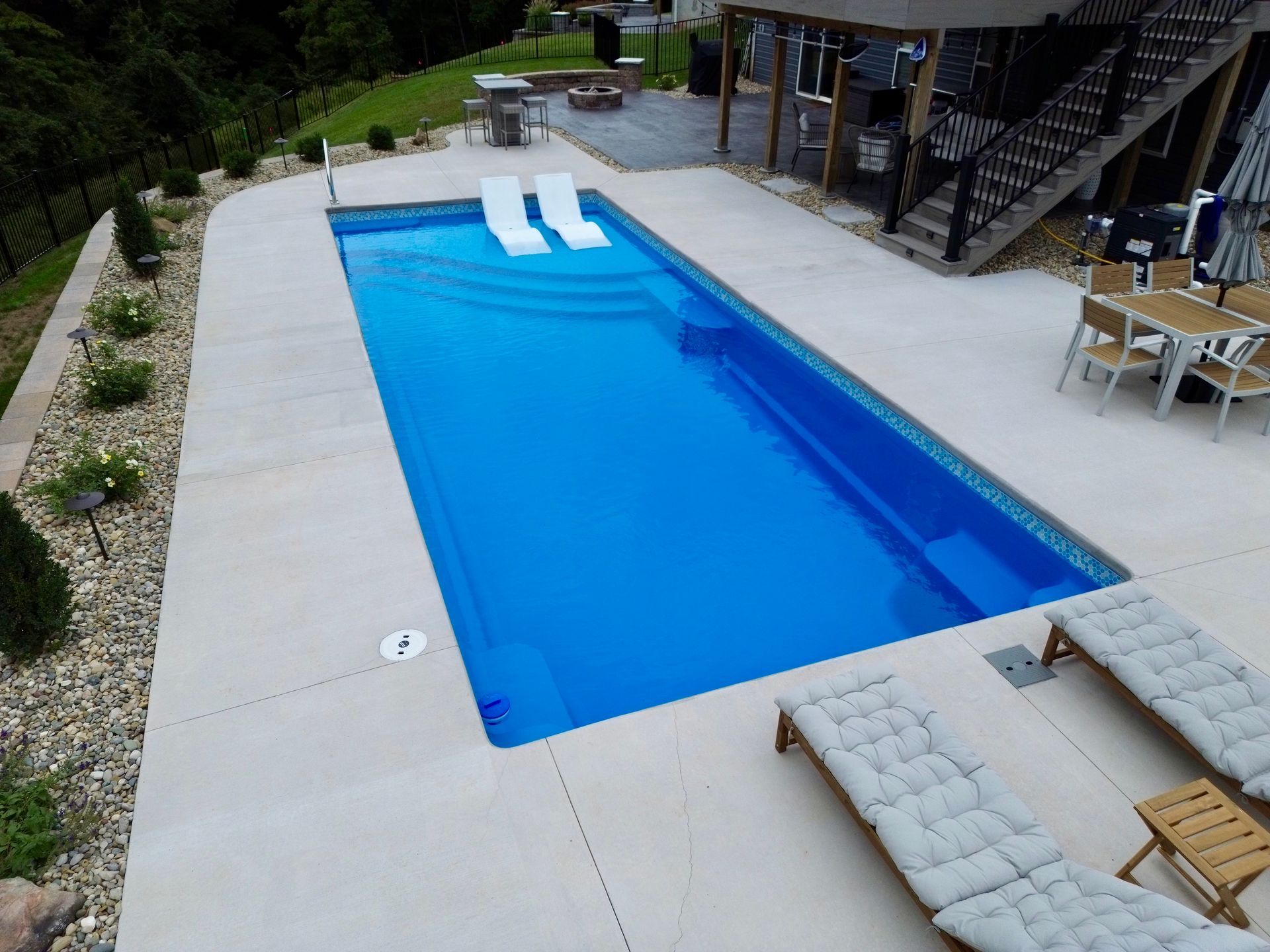 An aerial view of a large swimming pool in a backyard
