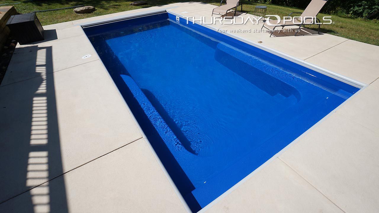 A large blue swimming pool with the word pools on the bottom
