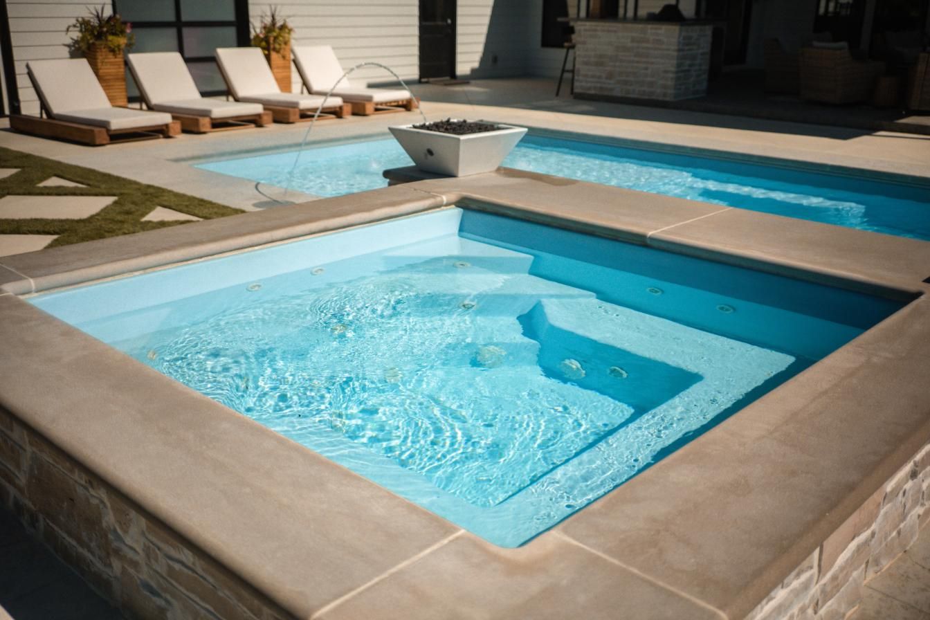 There are three swimming pools in the backyard of a house.