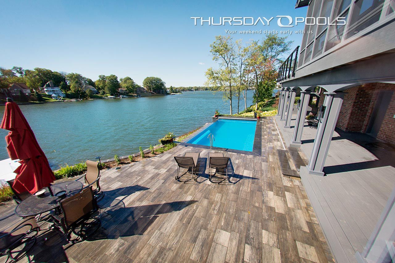 A large swimming pool is surrounded by a large body of water.