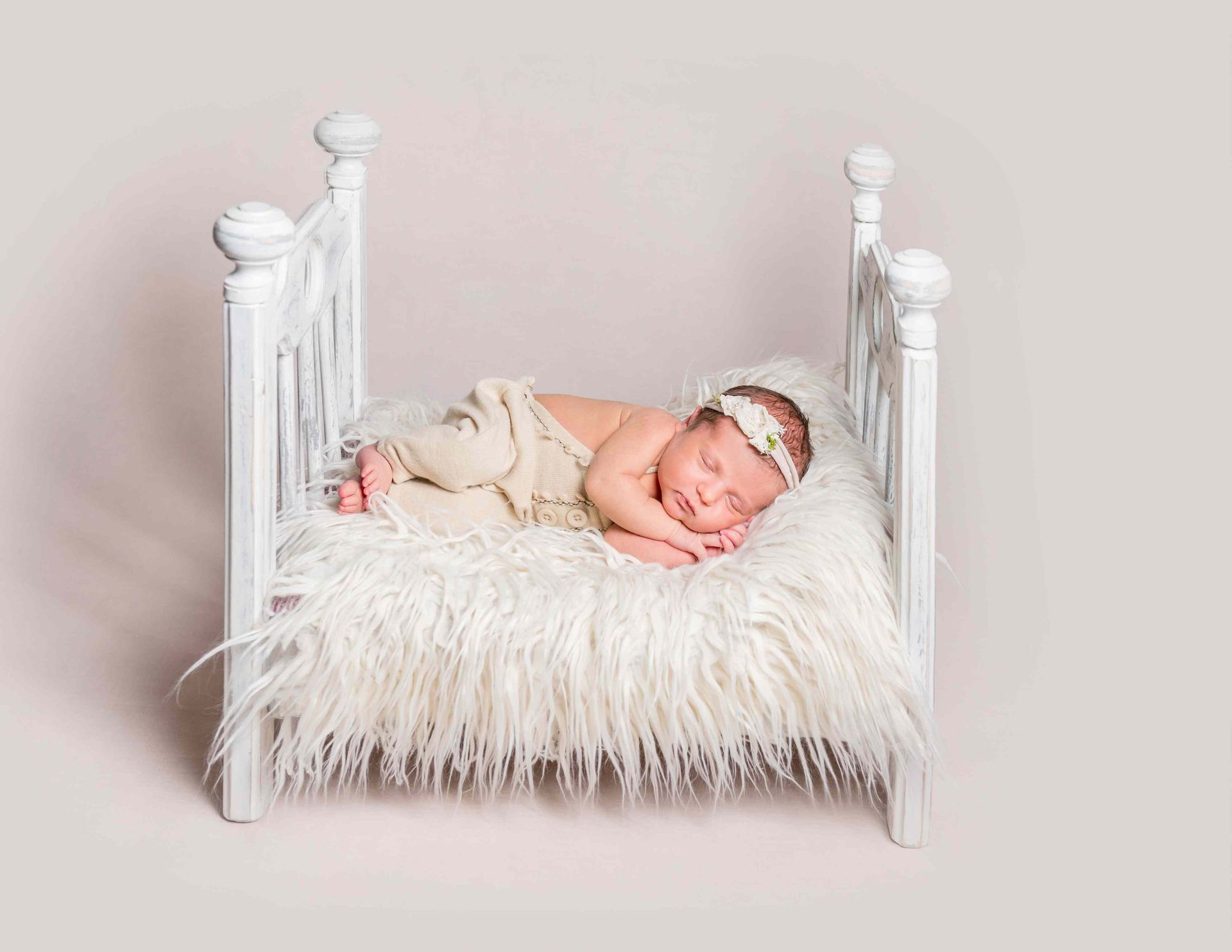 A baby in art pictures in a tiny bed taken by our photographer in Amarillo