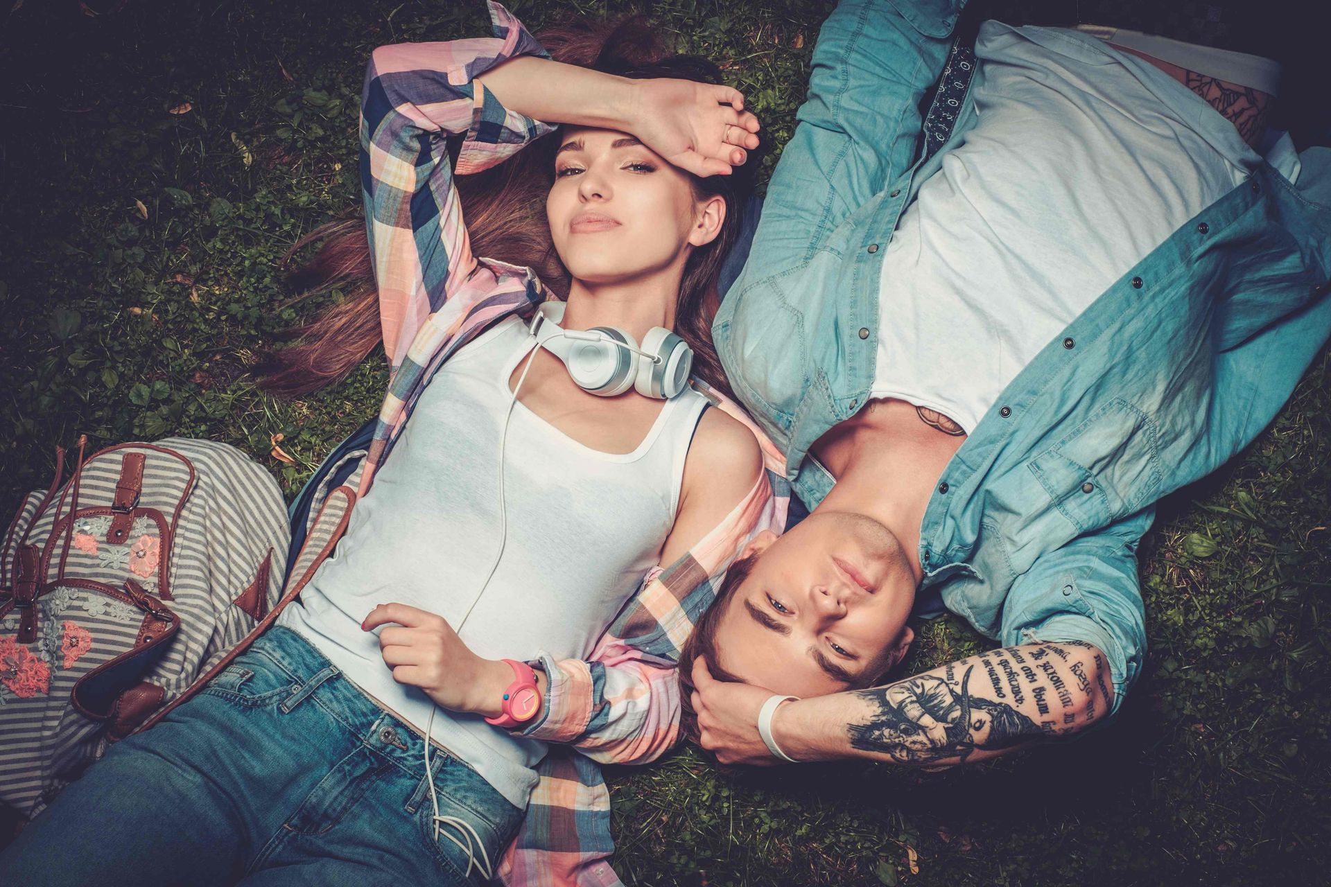 A young couple laying together in the grass in Amarillo