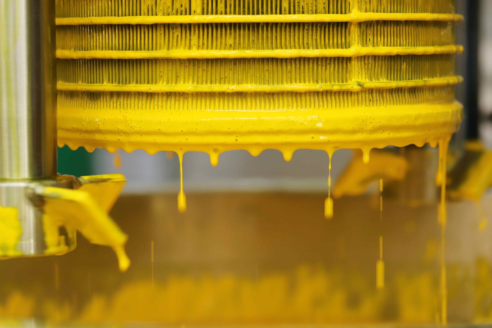 Commercial paint factory portrait of dripping yellow paint used for advertising