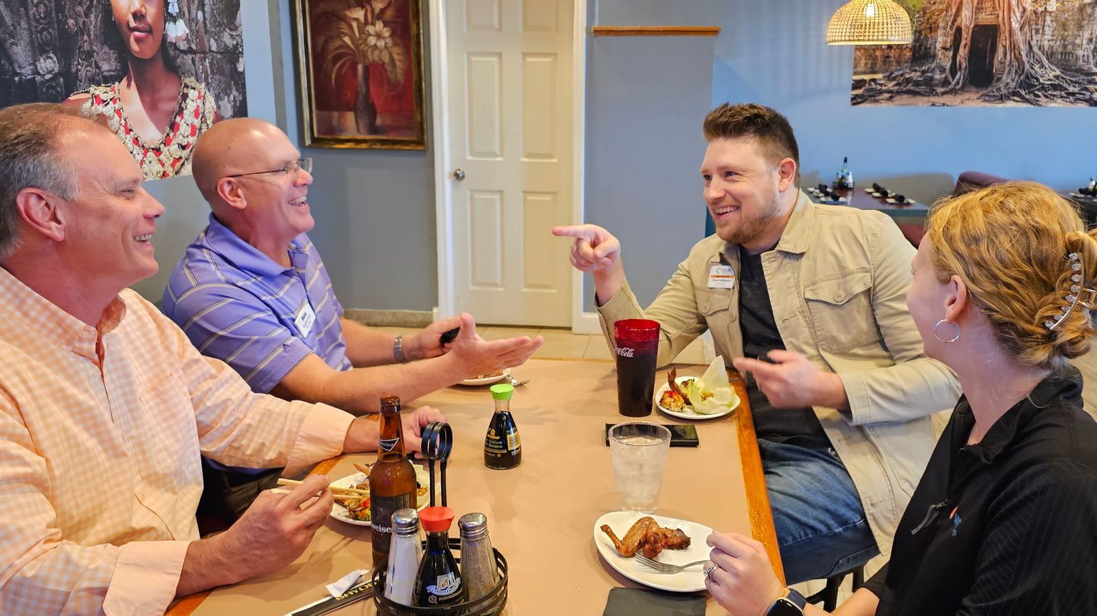 A group of people are sitting at a table eating food.