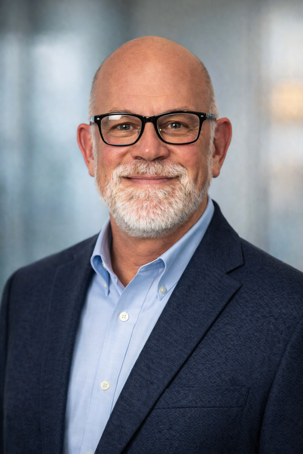 A man in a suit and tie is smiling for the camera.