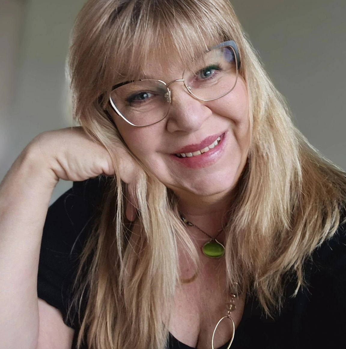 A man in a suit and tie is smiling for the camera.