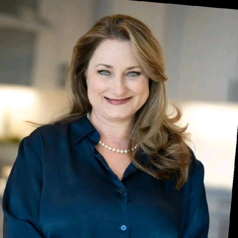 A man in a suit and tie is smiling for the camera.