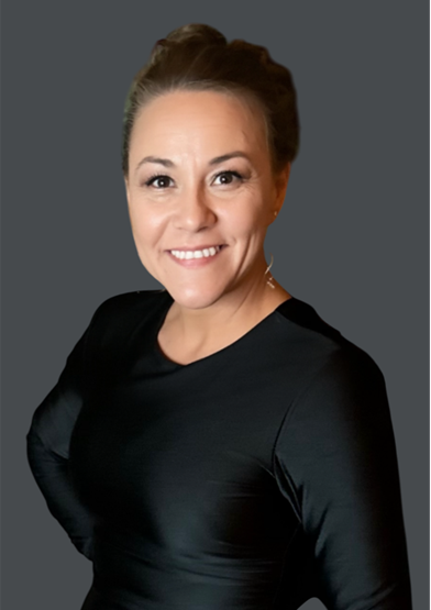 A woman in a black dress is smiling for the camera.