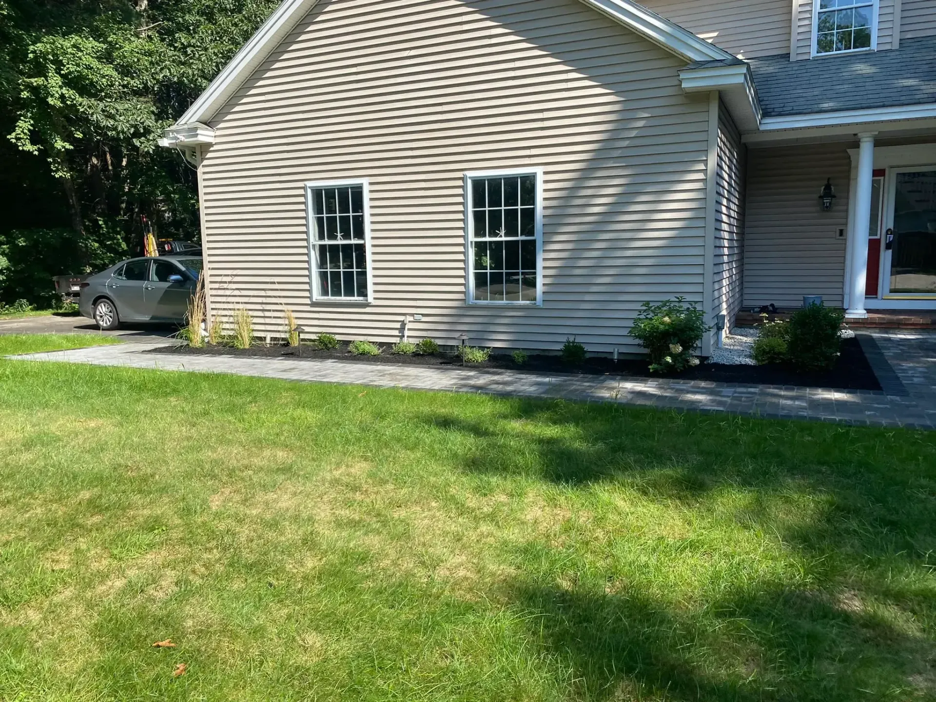 A house with a car parked in front of it
