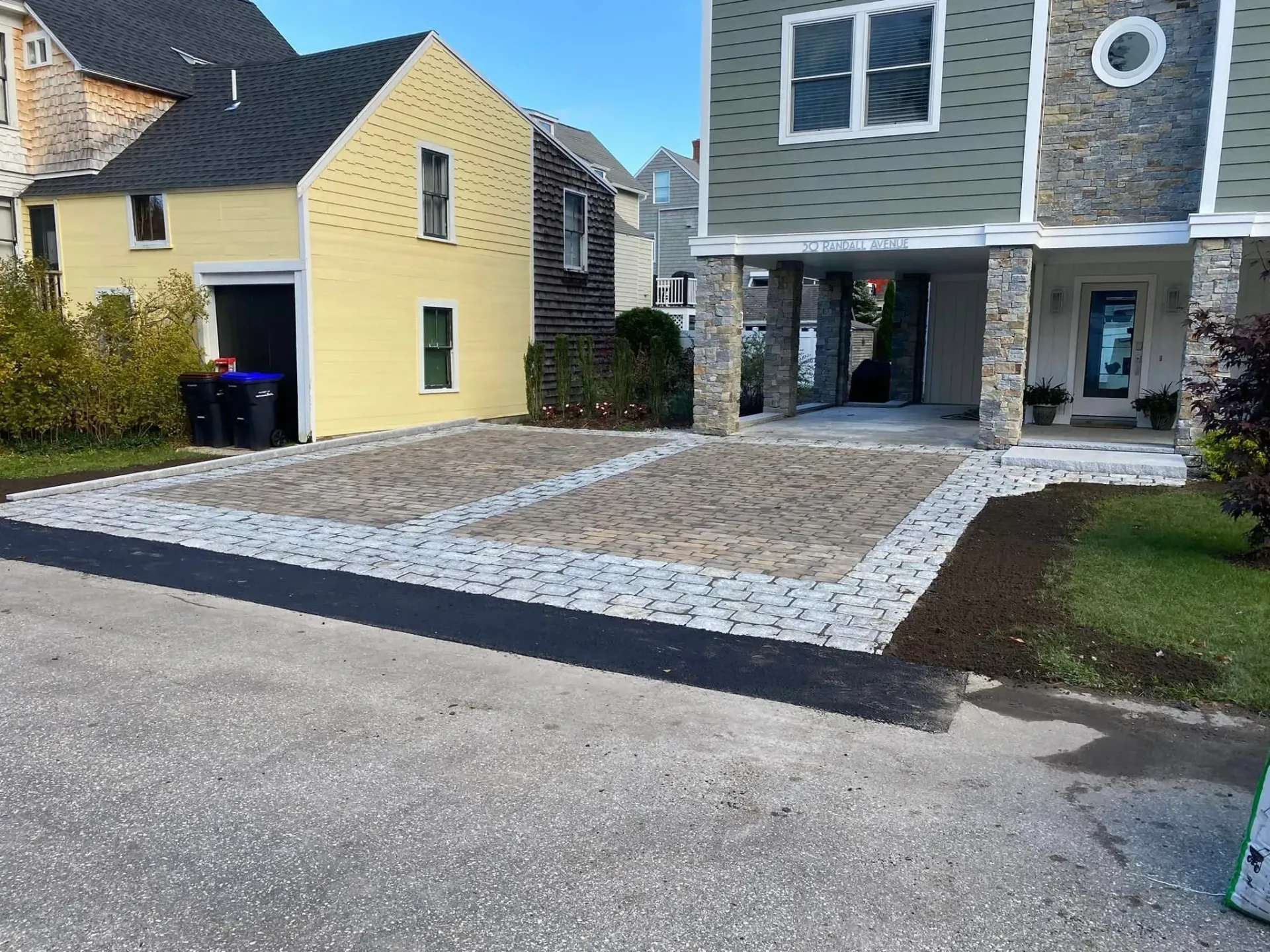 A house with a large driveway in front of it.
