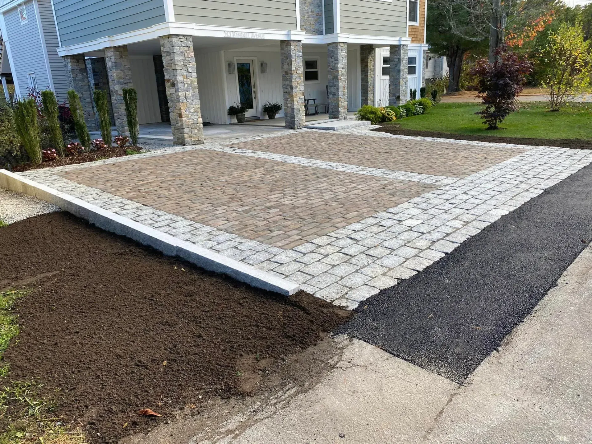 A driveway is being built in front of a house.