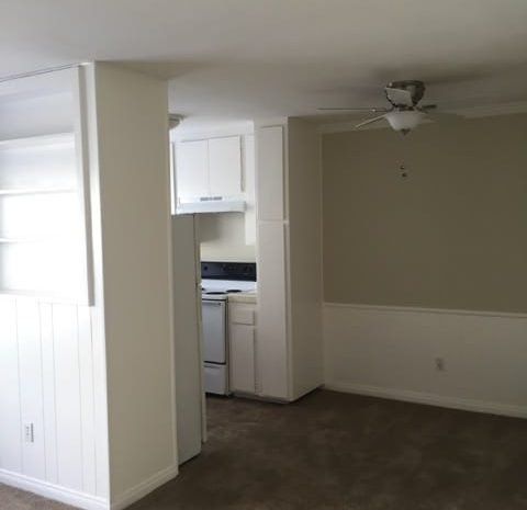 Carpeted dining area with a ceiling fan