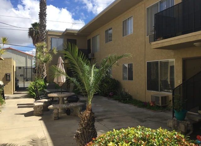Patio area with concrete table; located next to apartments