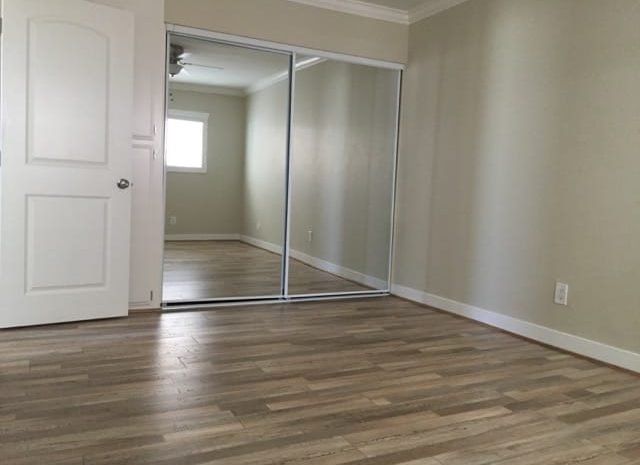 Bedroom with a closet and hardwood floors