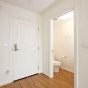 Apartment interior with a bathroom; hardwood flooring