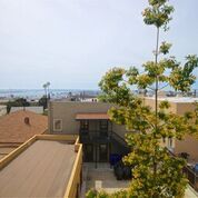 View from apartment over other buildings, the ocean is a mile or two away