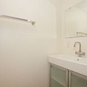 Bathroom with sink that has a wide basin but very little counter space