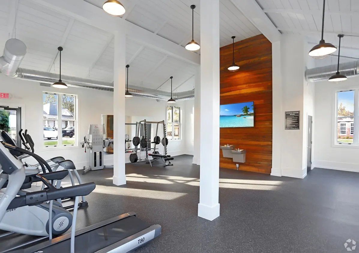 Well-equipped gym interior with cardio machines and weights