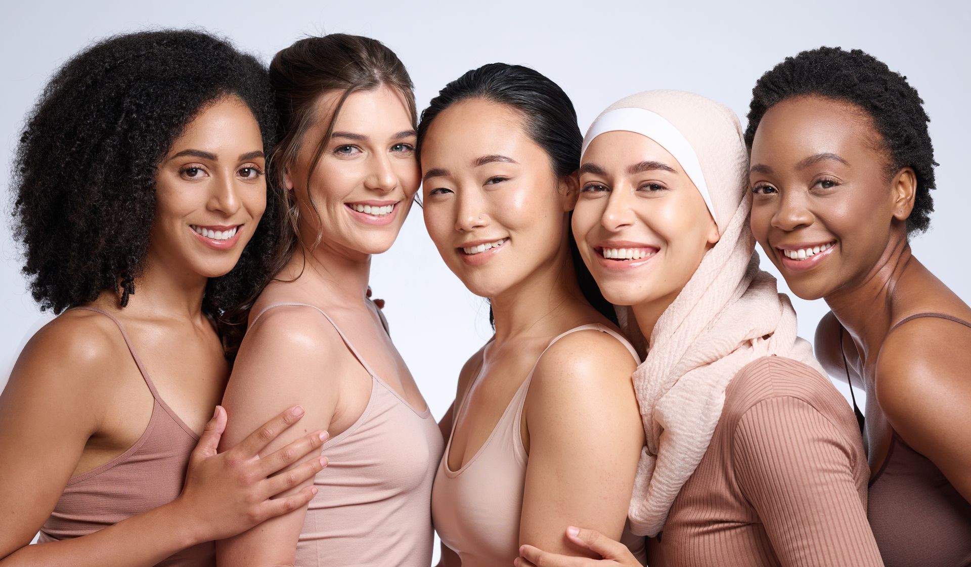 A group of women of different races are posing for a picture together.