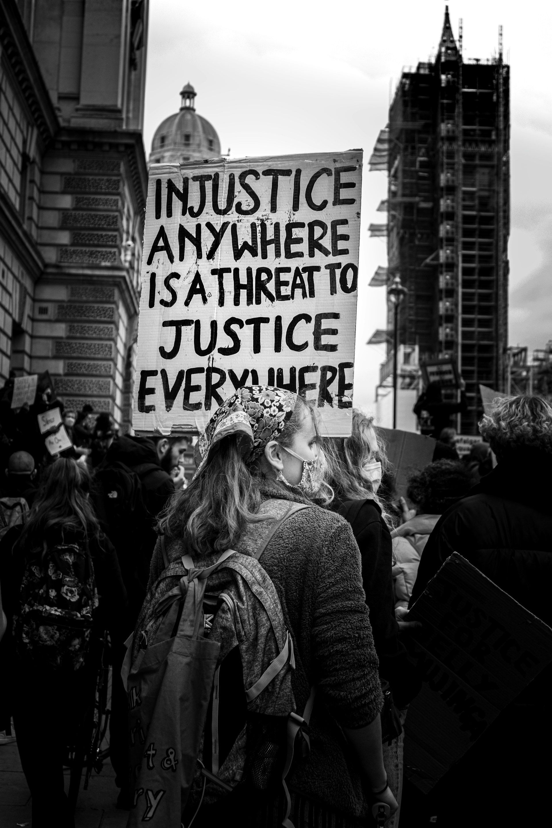 A black and white photo of a group of people holding signs.