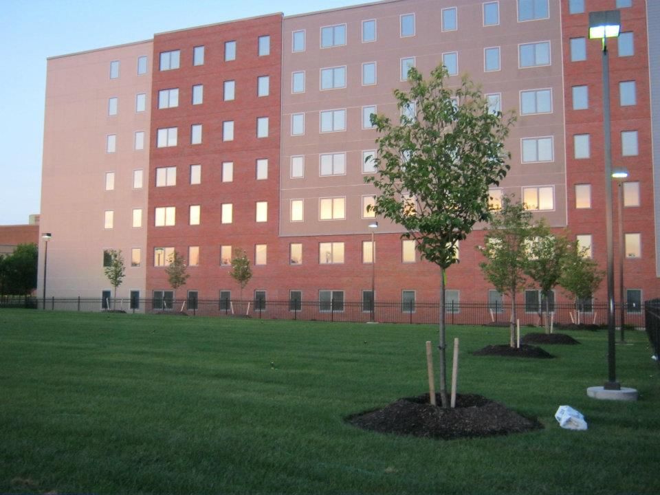 A large building with a lot of windows and trees in front of it