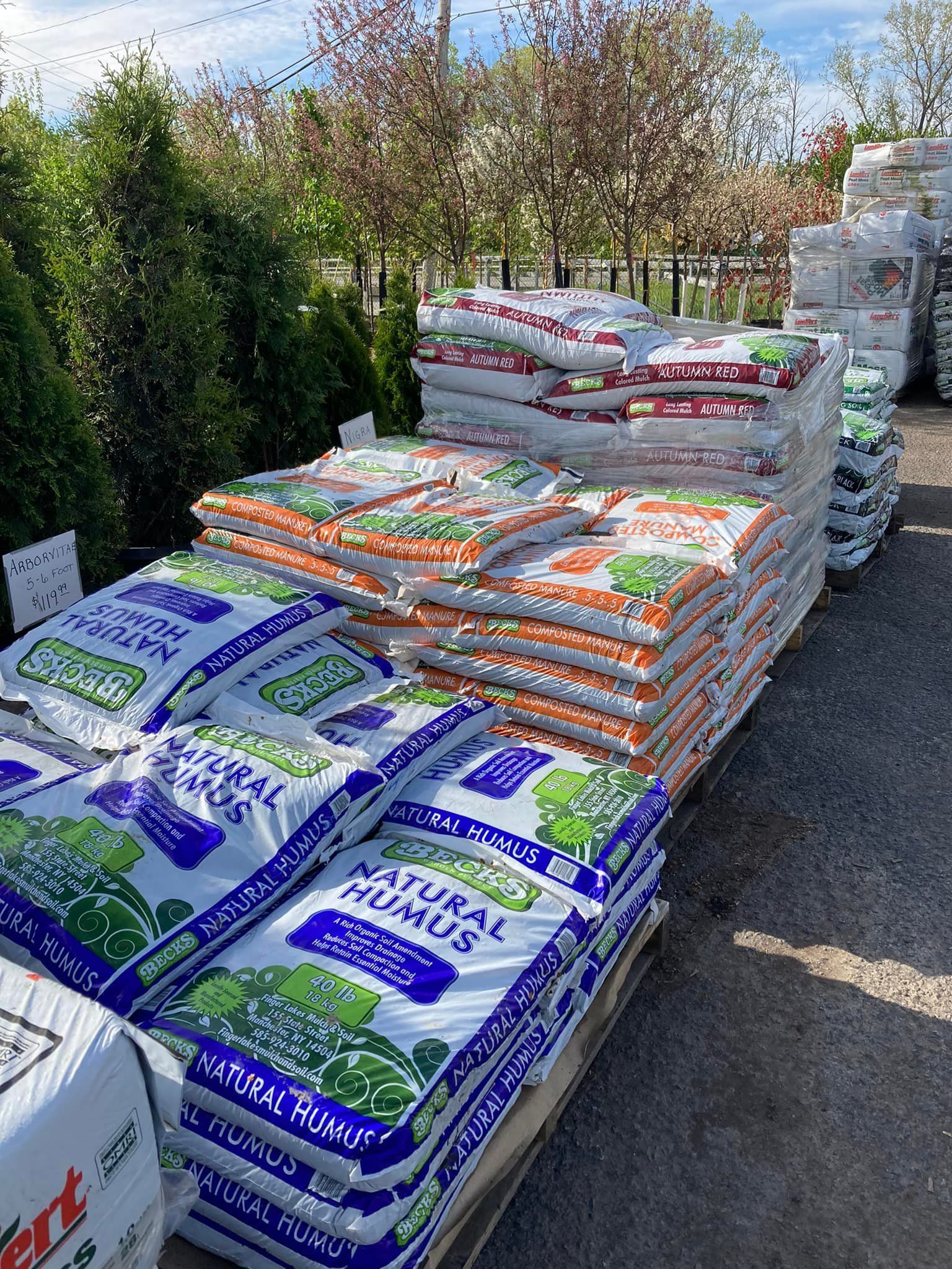A bunch of bags of soil are stacked on top of each other on a pallet.
