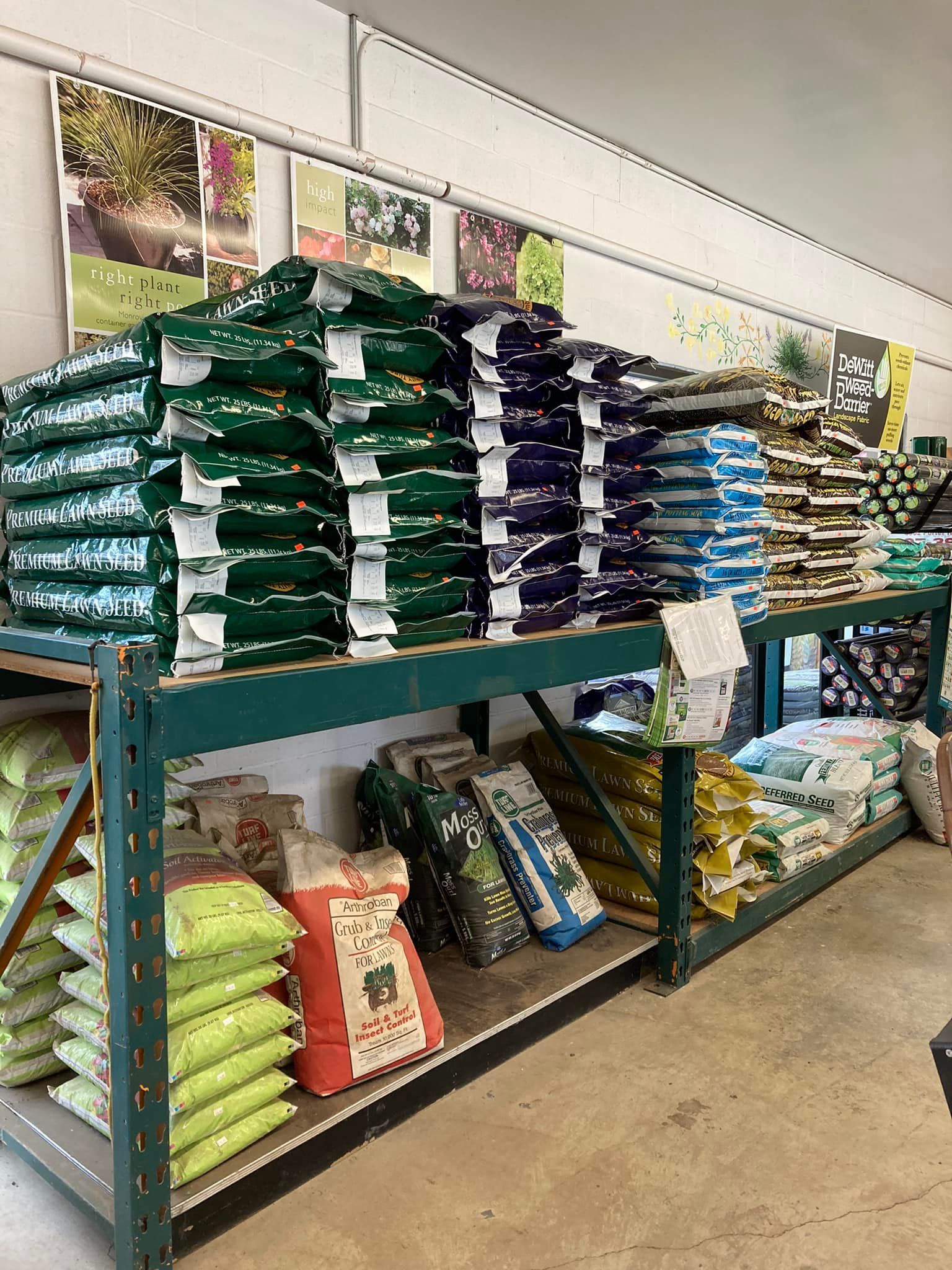 A shelf filled with bags of fertilizer in a store.