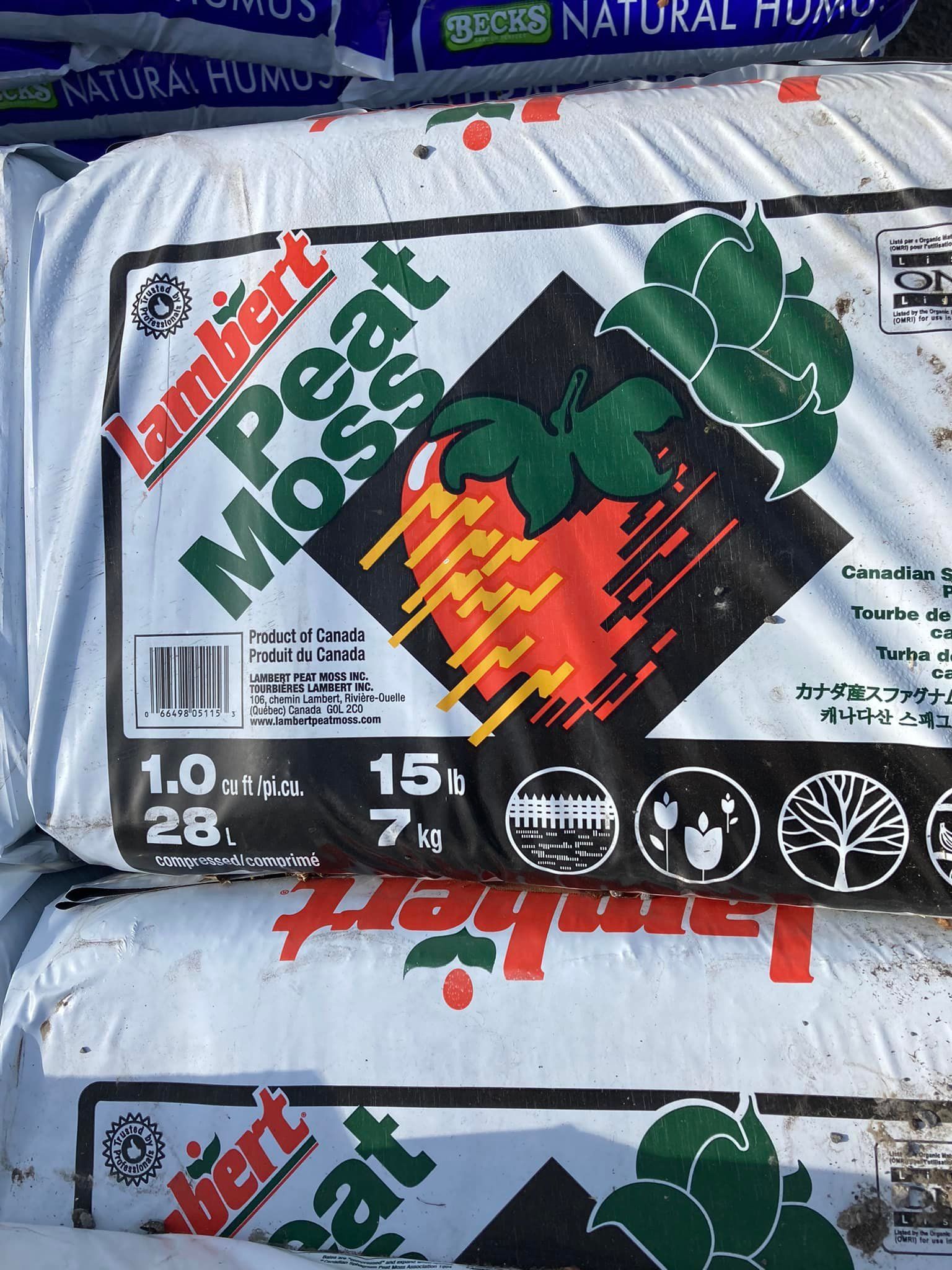 A bag of lambert peat moss sits on top of other bags