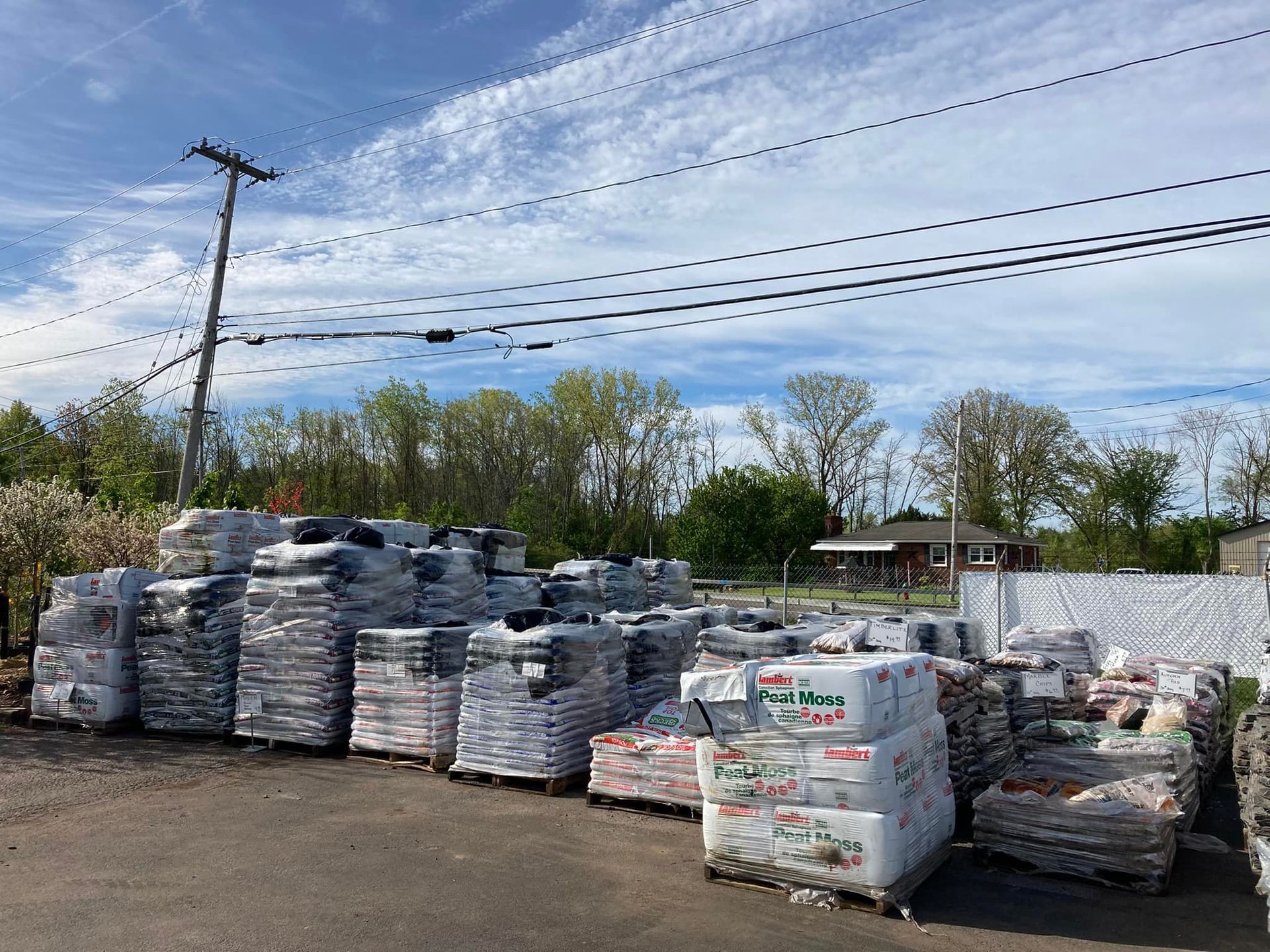 A warehouse filled with lots of bags of soil and bricks.